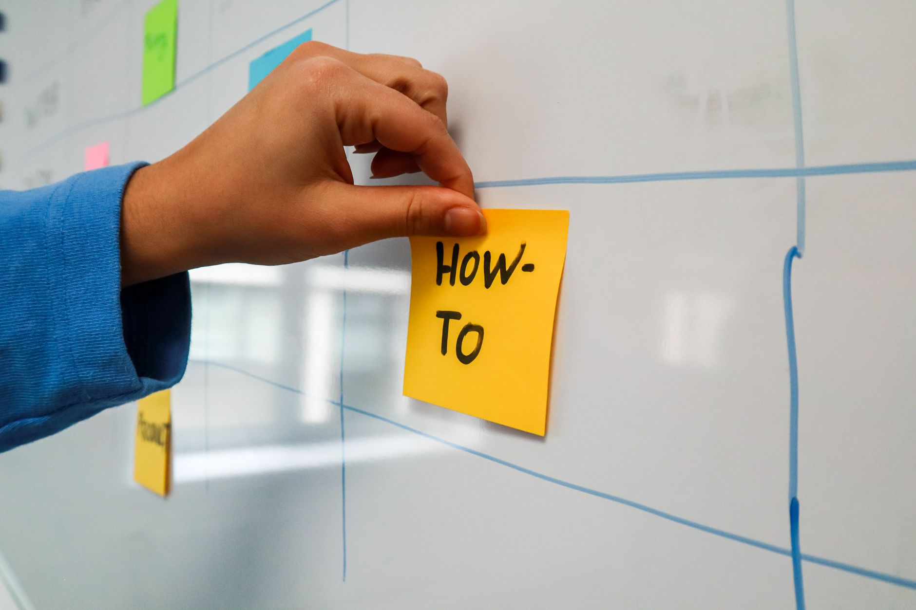 Two startup employees pointing at a visual sales pipeline on a monitor