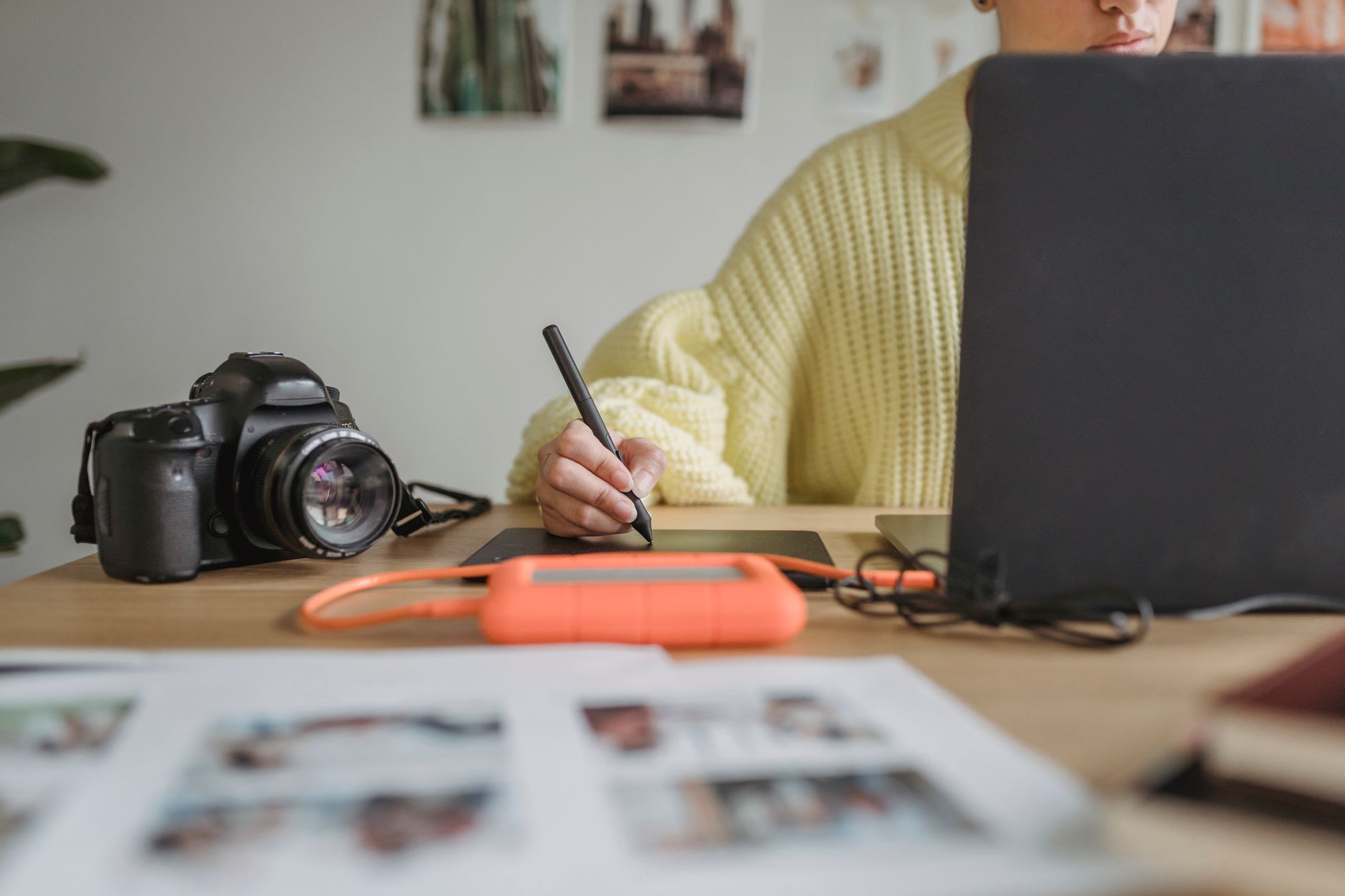 a graphic designer editing a social media post template on a tablet with color swatches nearby