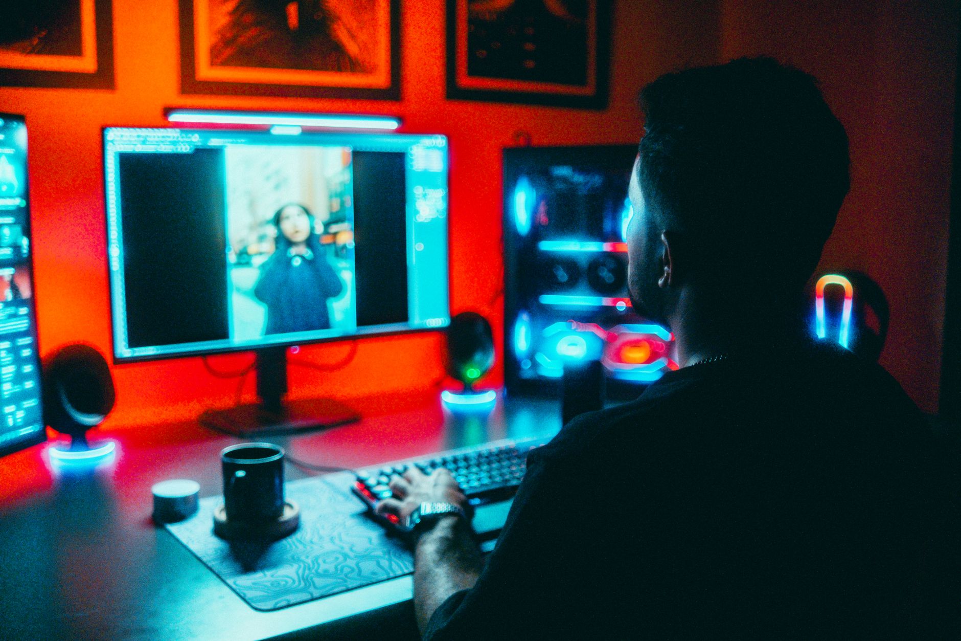 a digital artist generating AI art on a desktop with a colorful portrait visible on screen