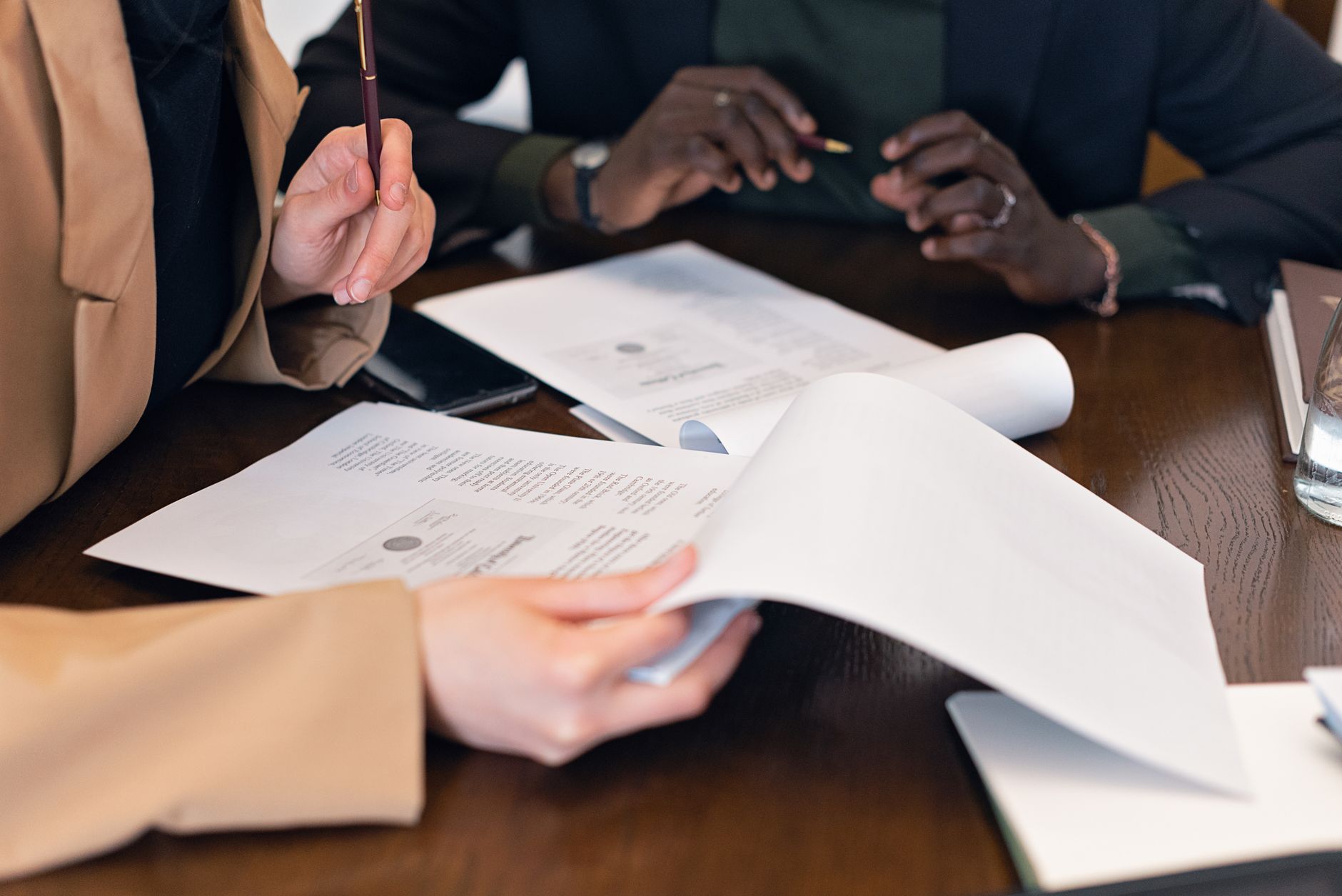 a consultant reviewing printed documents at a conference table