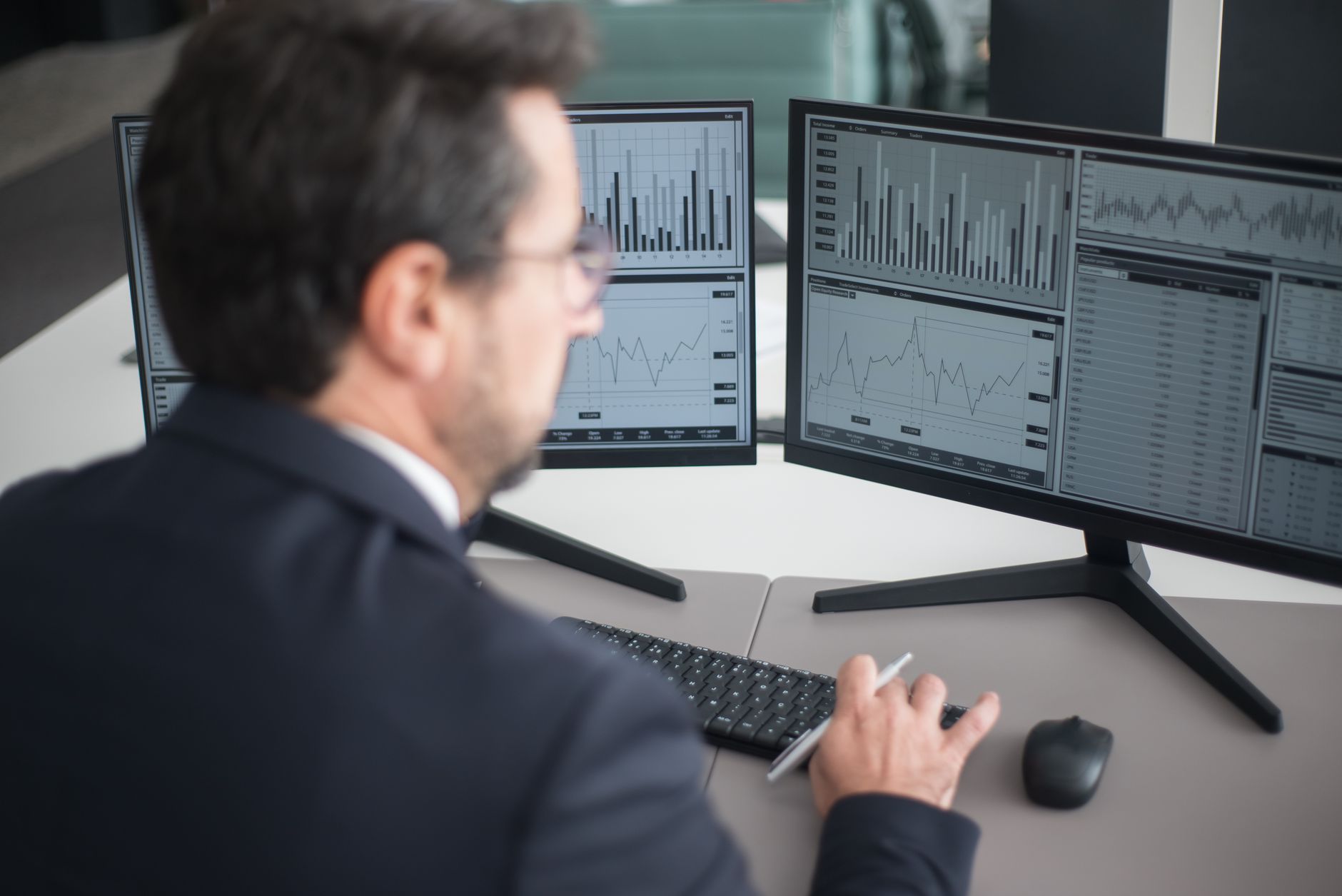 a person working with large data on a monitor showing Google Sheets and charts