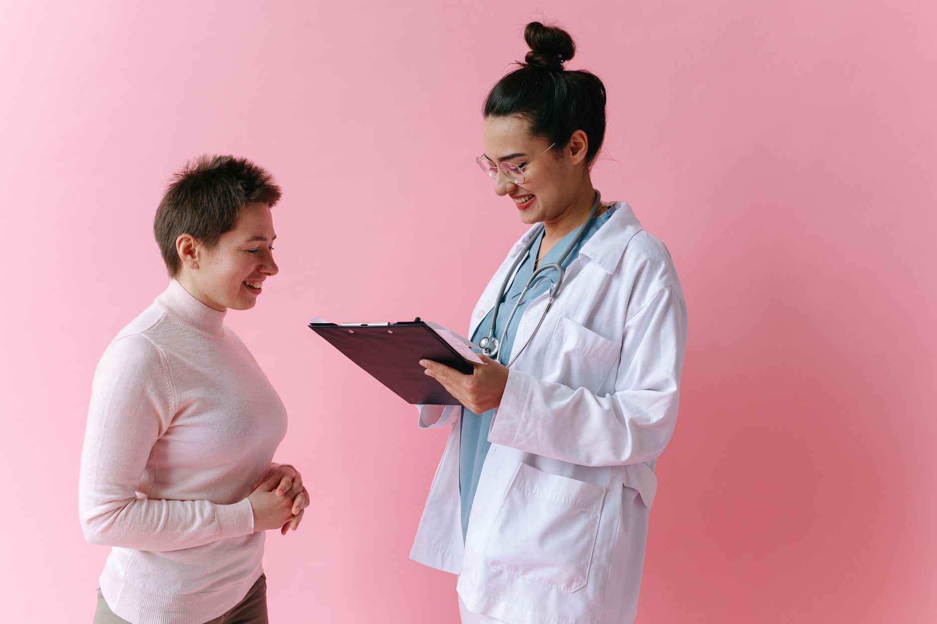 doctor showing a tablet with test results to a patient in an exam room