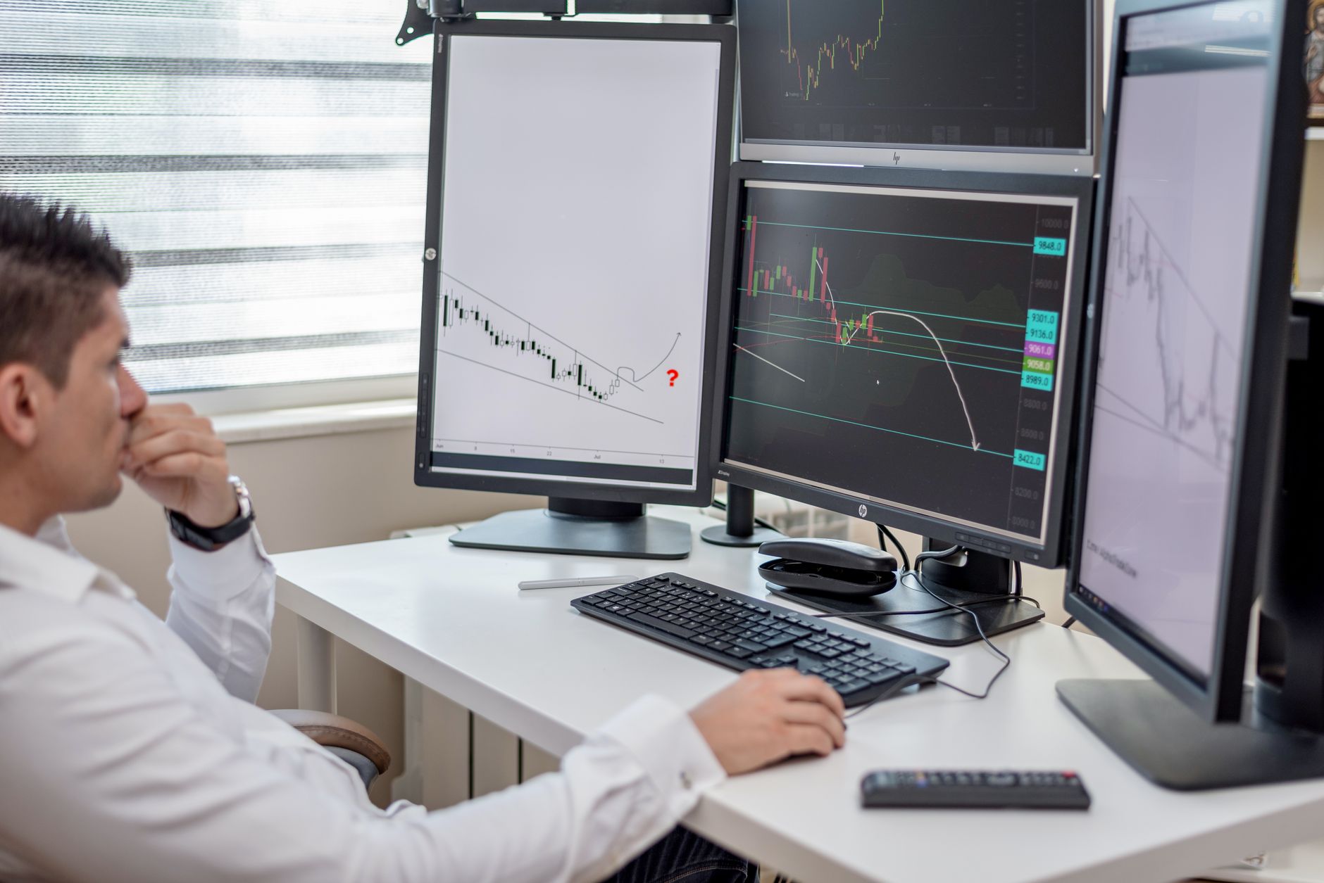 a data analyst reviewing email performance charts on a computer monitor