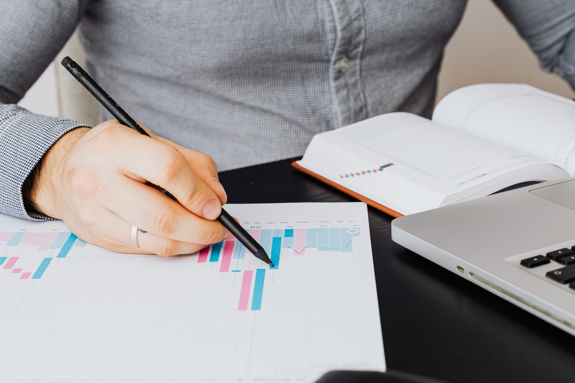 founder reviewing a spreadsheet with charts on a laptop screen