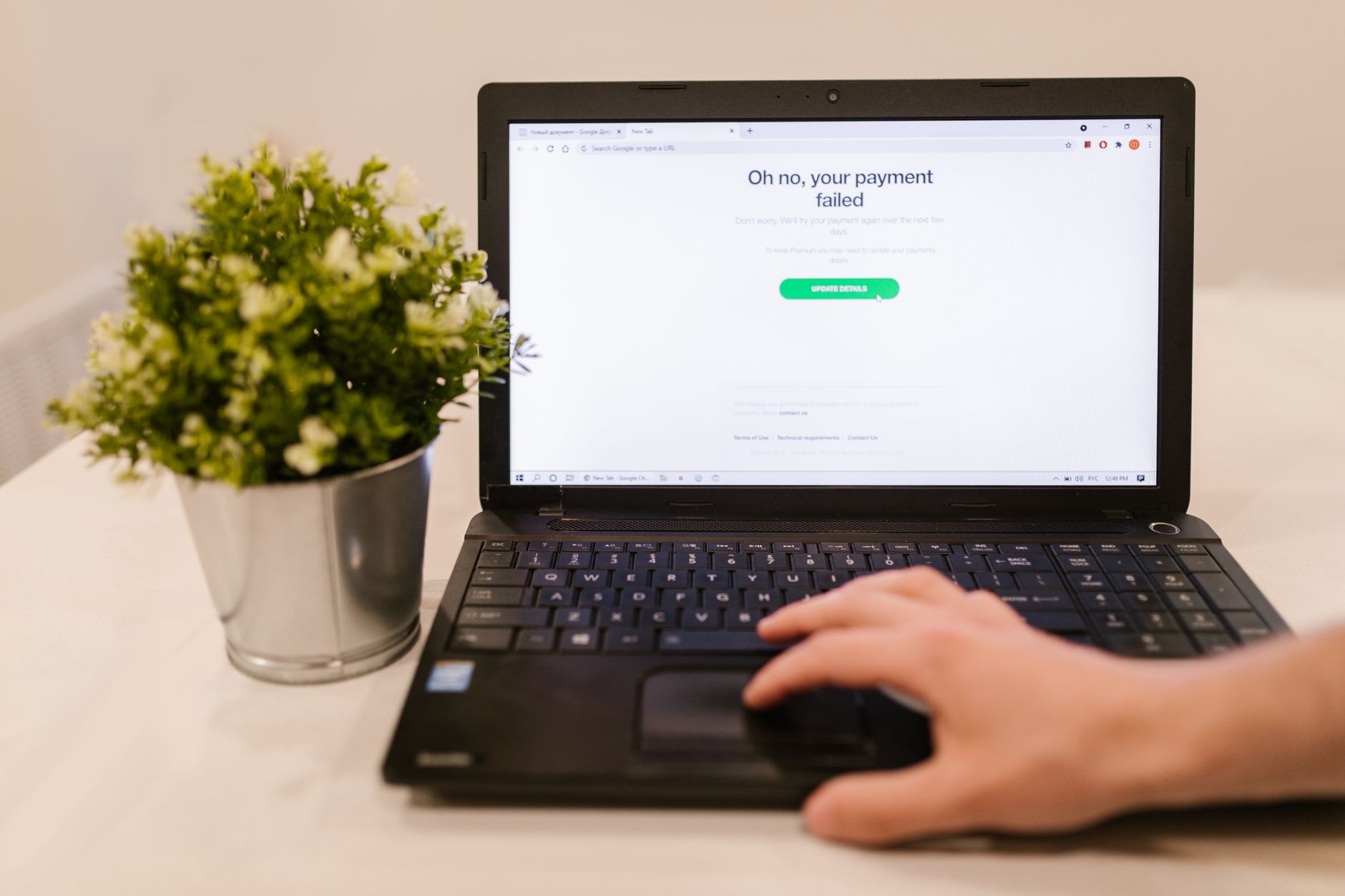 a laptop on a desk showing an invoice dashboard with a pay now button