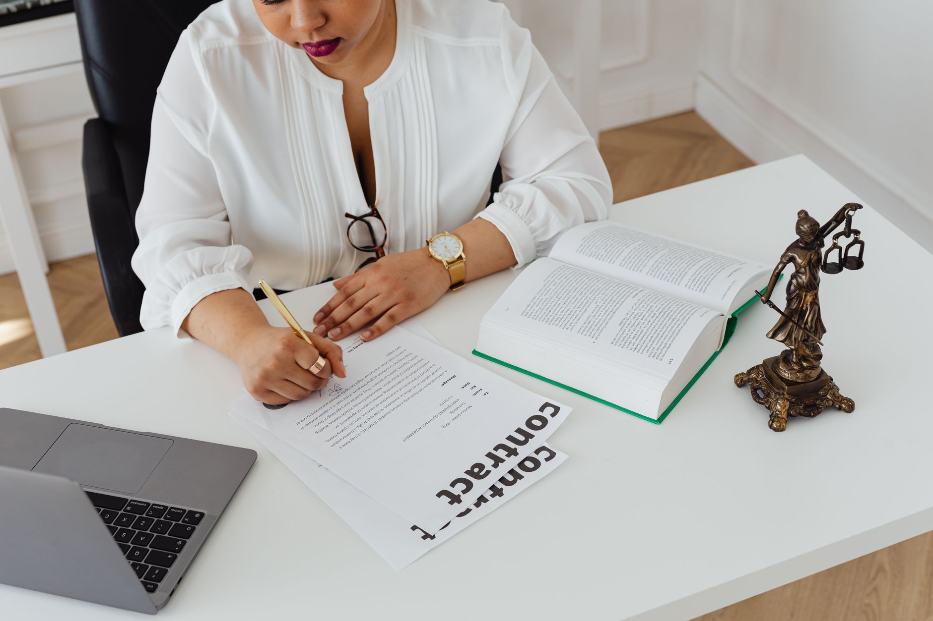 an attorney drafting a contract in Microsoft Word on a laptop