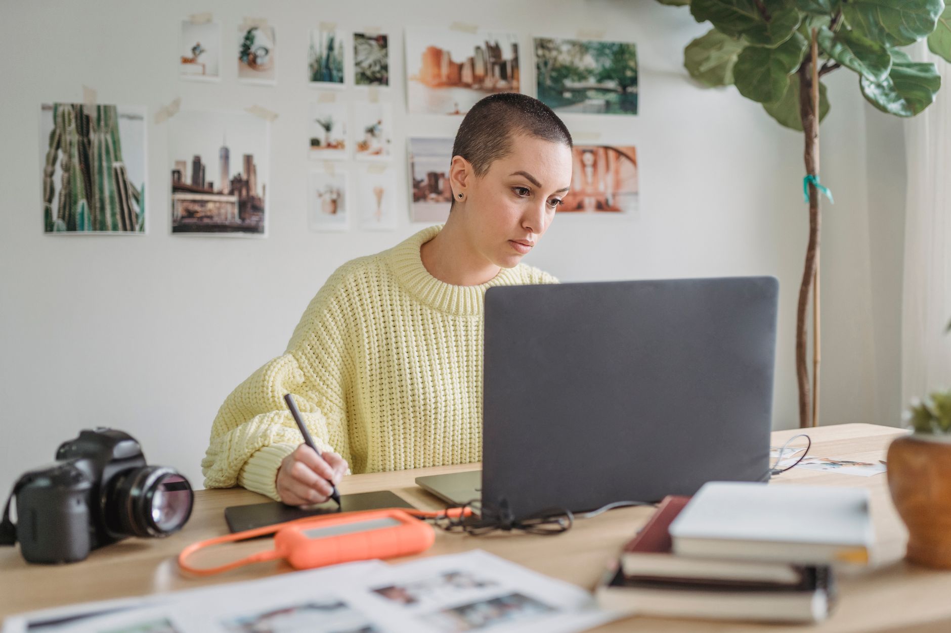 a volunteer designing a social media graphic on a laptop in a nonprofit office