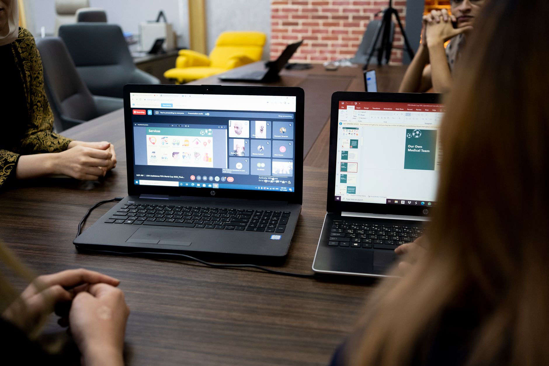 a professional meeting with a laptop video call and transcription notes on screen