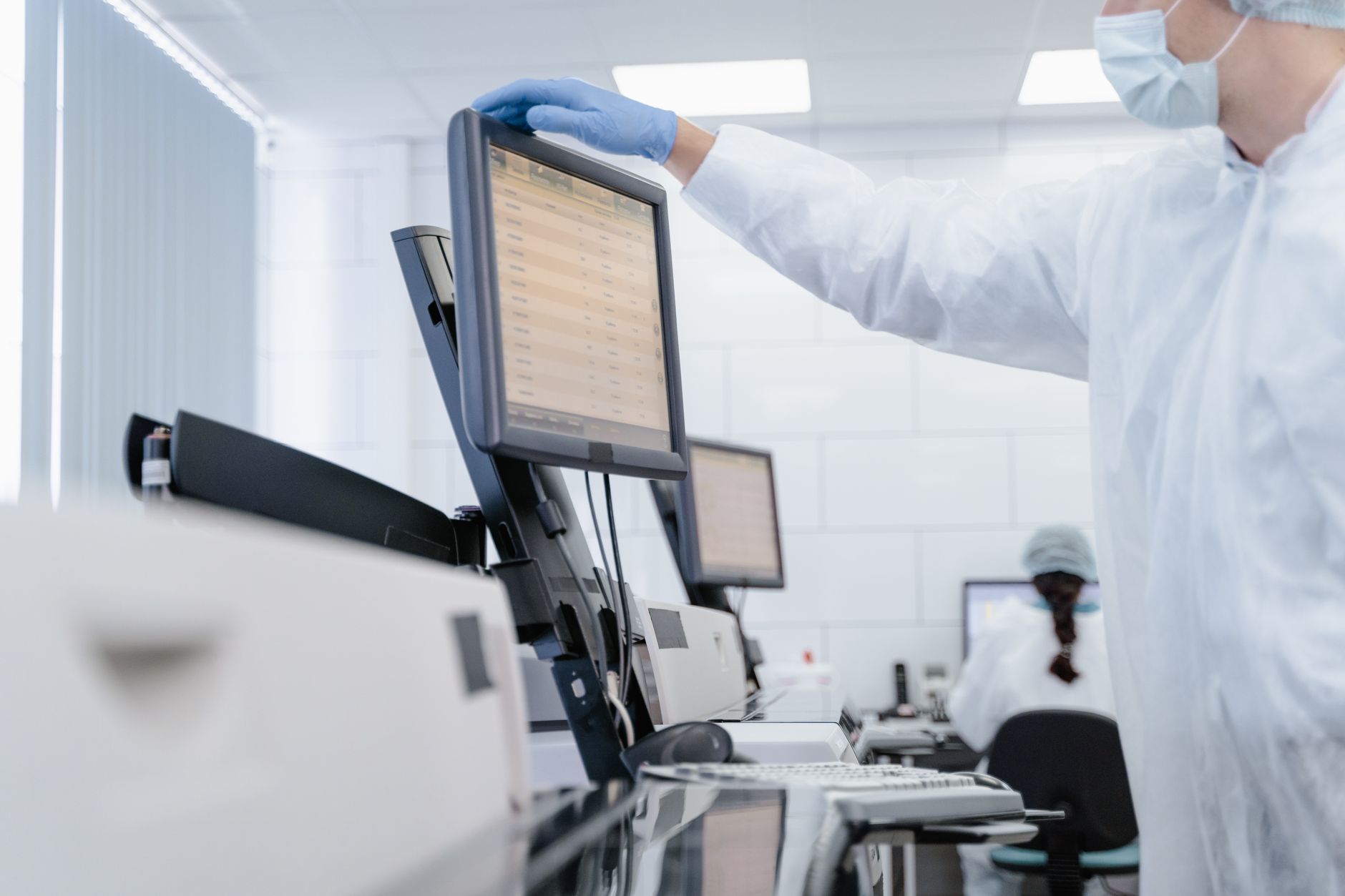 a pharmacist reviewing medication information on a computer screen in a pharmacy