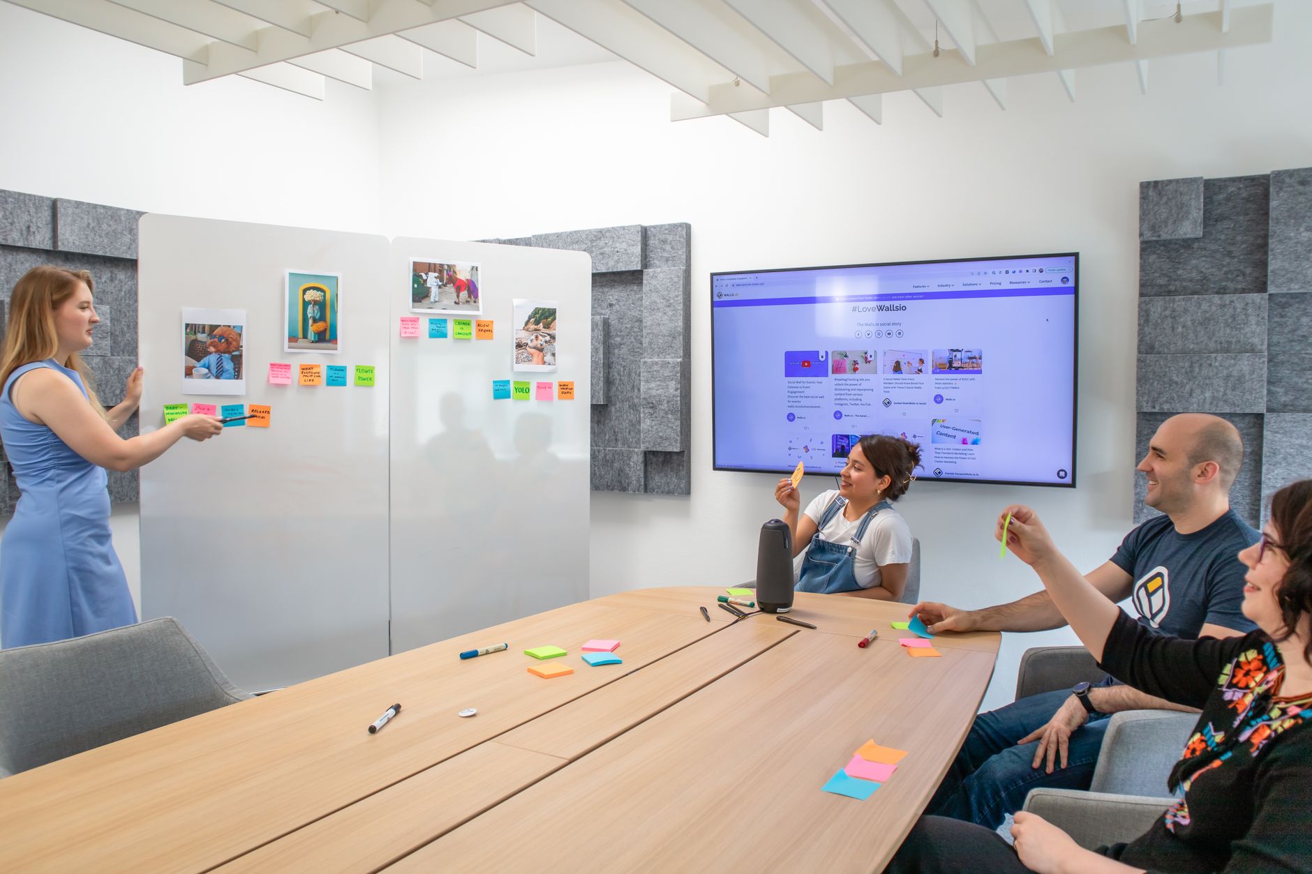 a team placing sticky notes on a whiteboard during a workshop