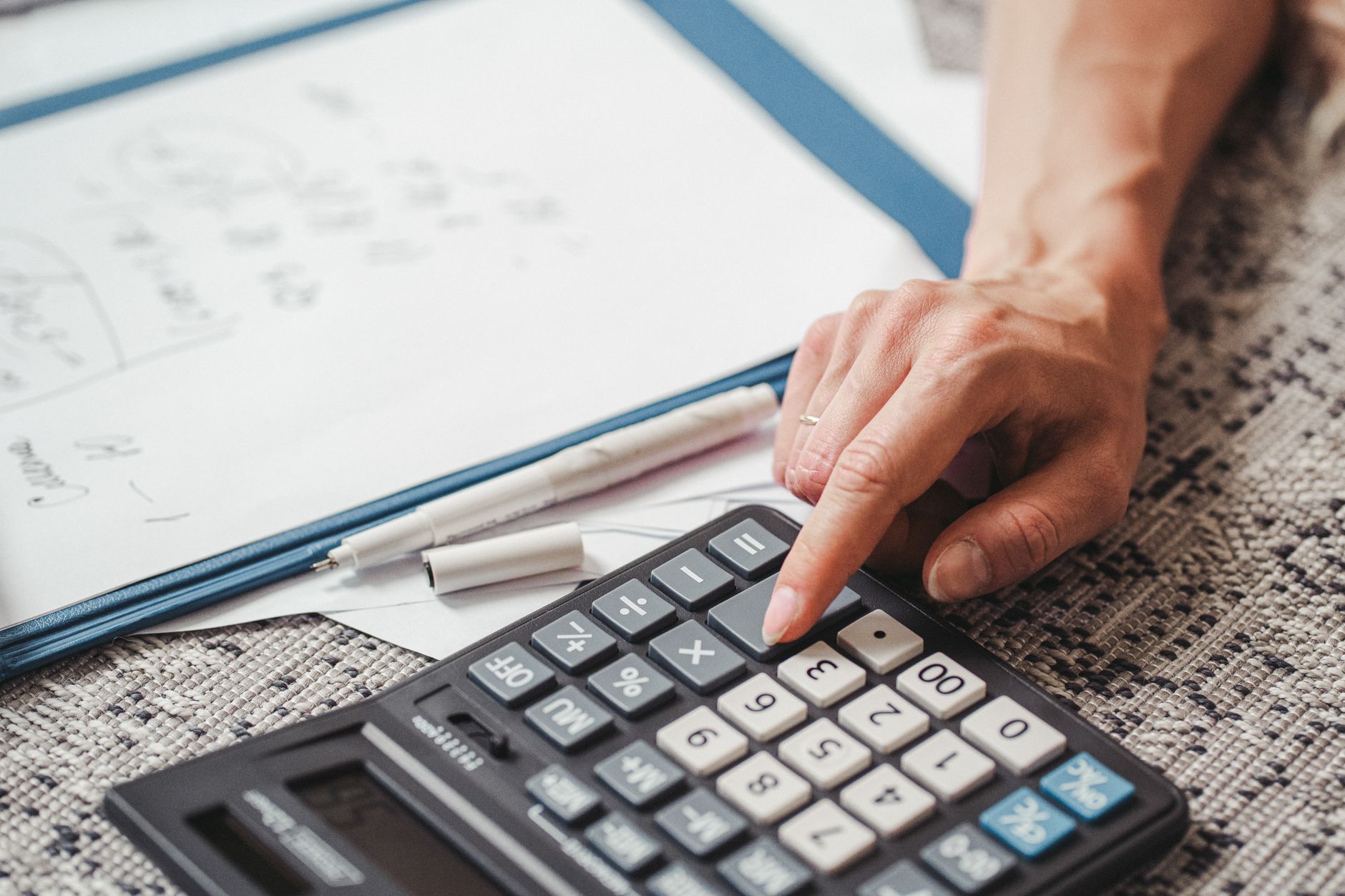 An investor reviewing a rental property underwriting spreadsheet on a computer monitor
