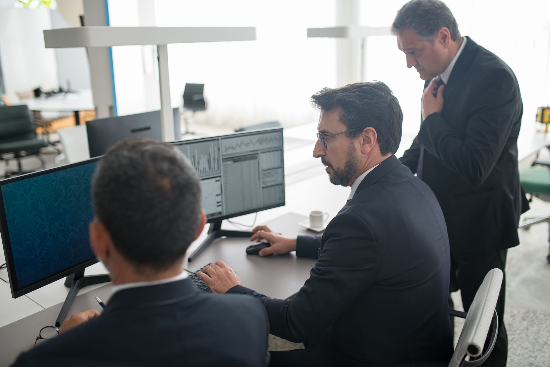 a marketing team analyzing keyword data on a large computer monitor