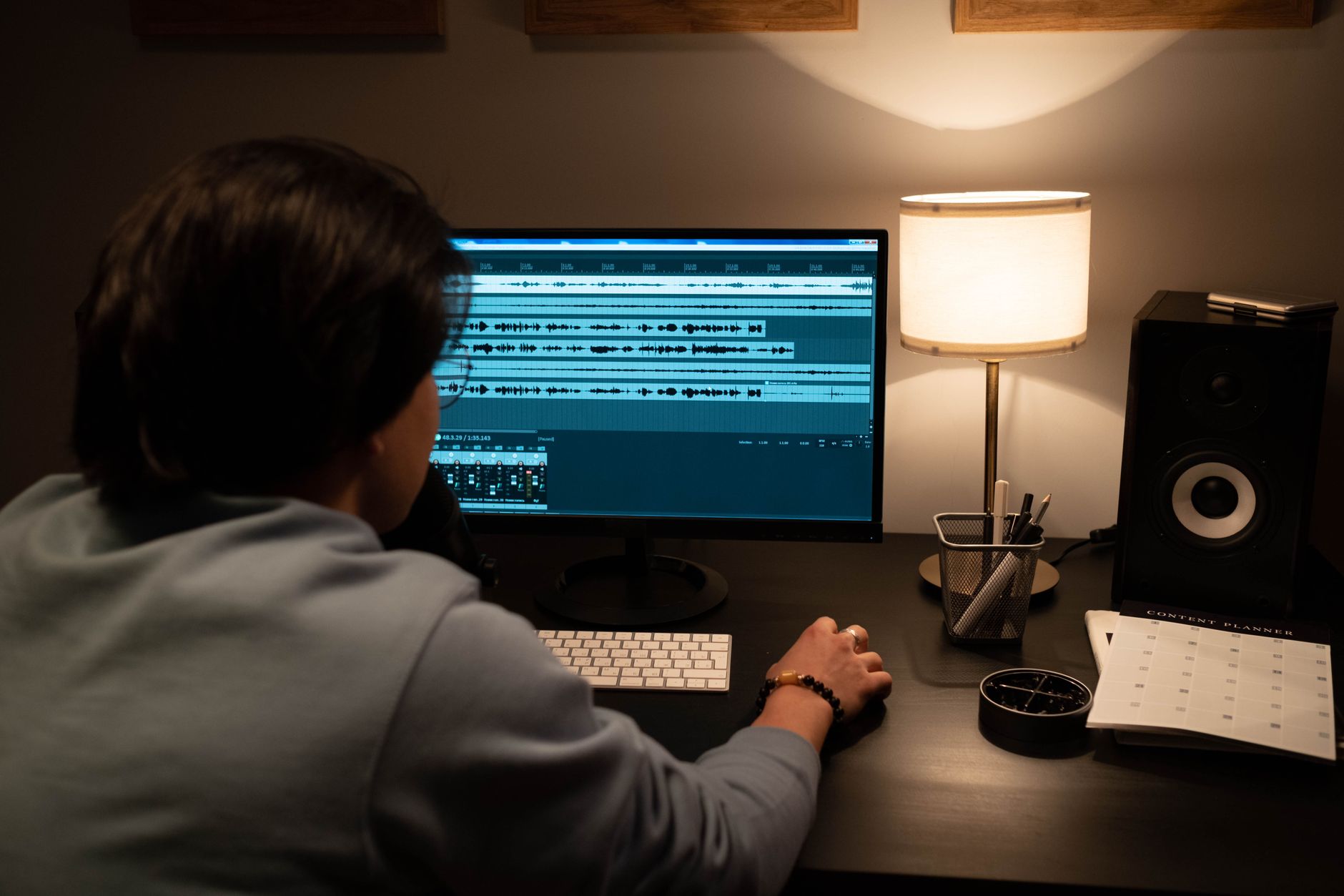 developer looking at transcription API dashboard with audio waveform on a computer screen