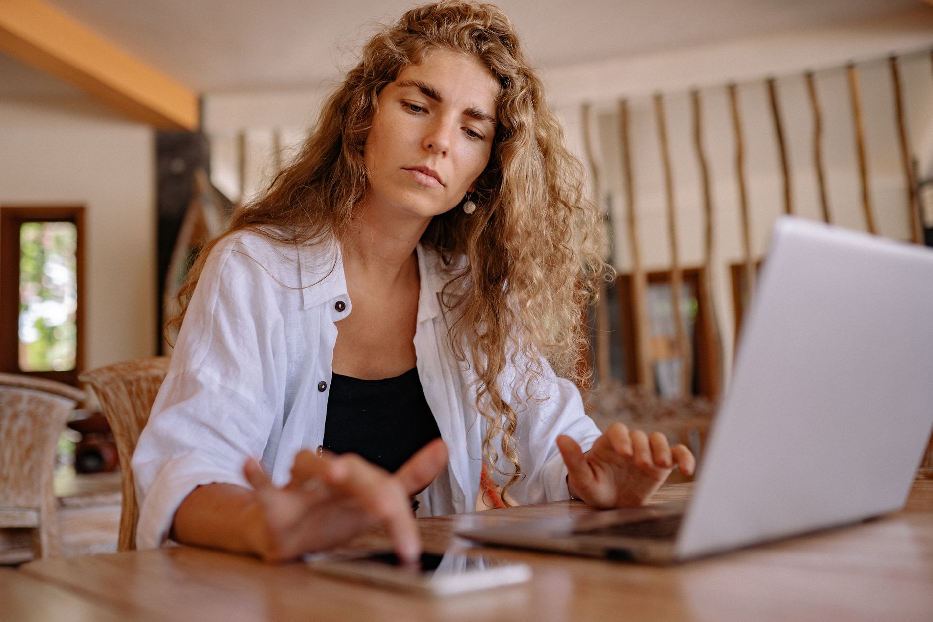 a veterinary receptionist using a computer and phone at the front desk