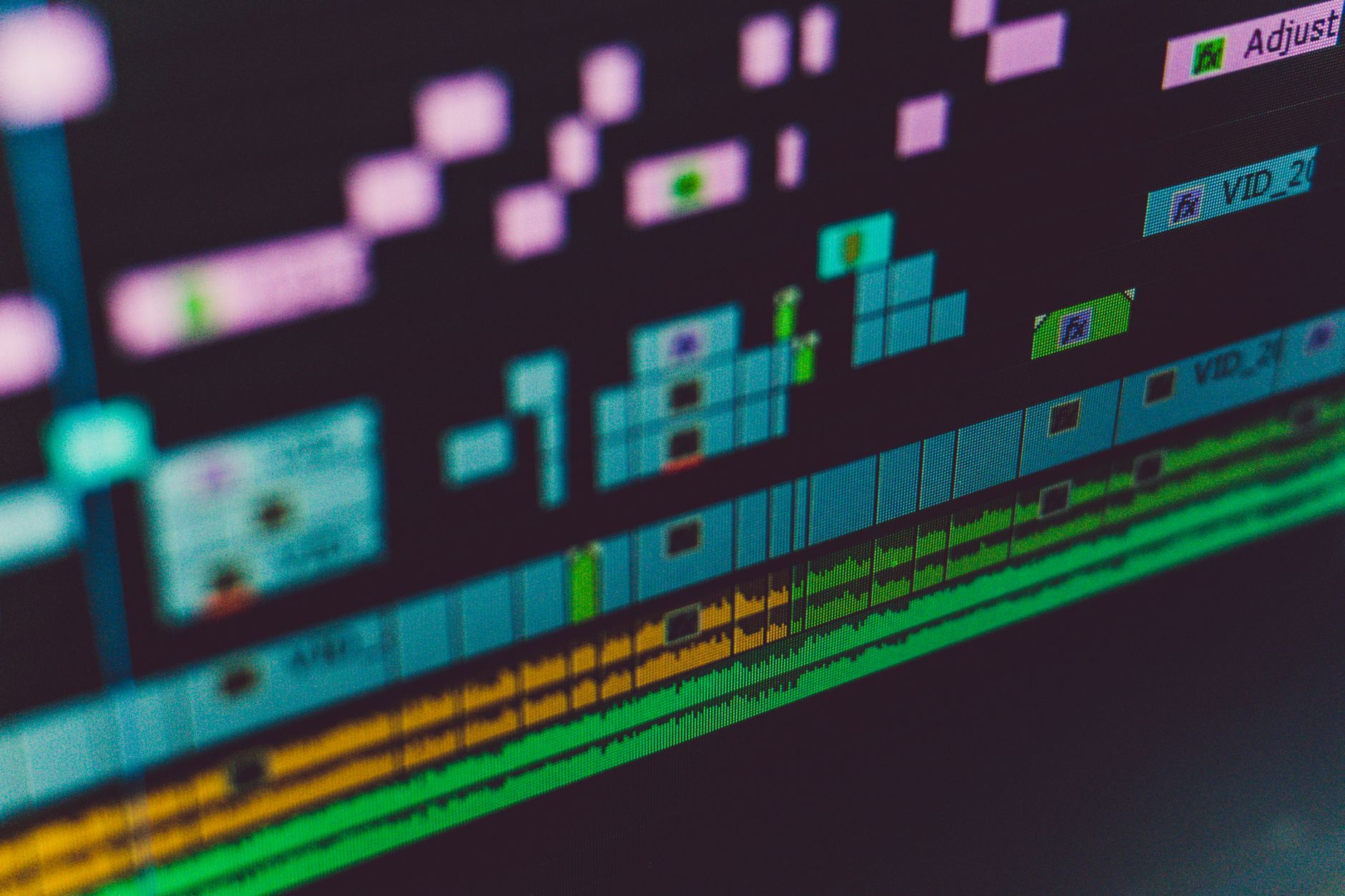 a video editor editing a timeline on a computer monitor with a transcript panel open