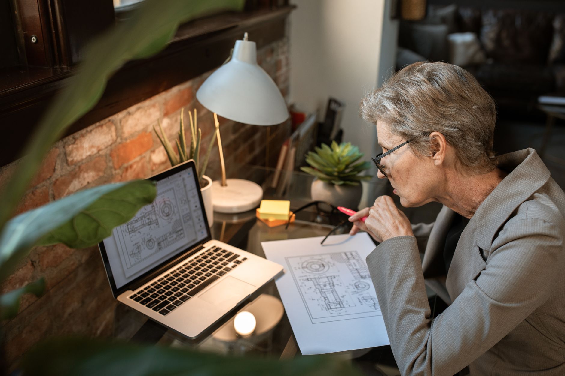 a small business owner reviewing financial charts on a laptop in a home office
