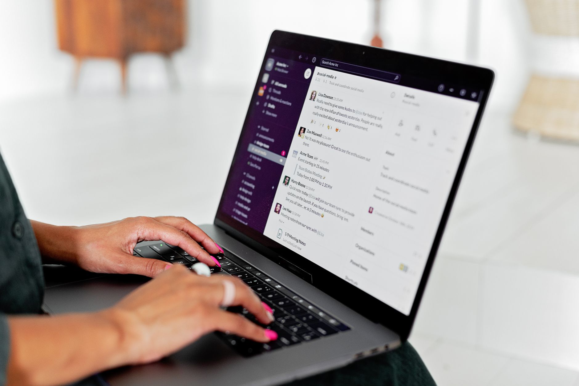 Person typing on a laptop showing an AI chat interface on screen