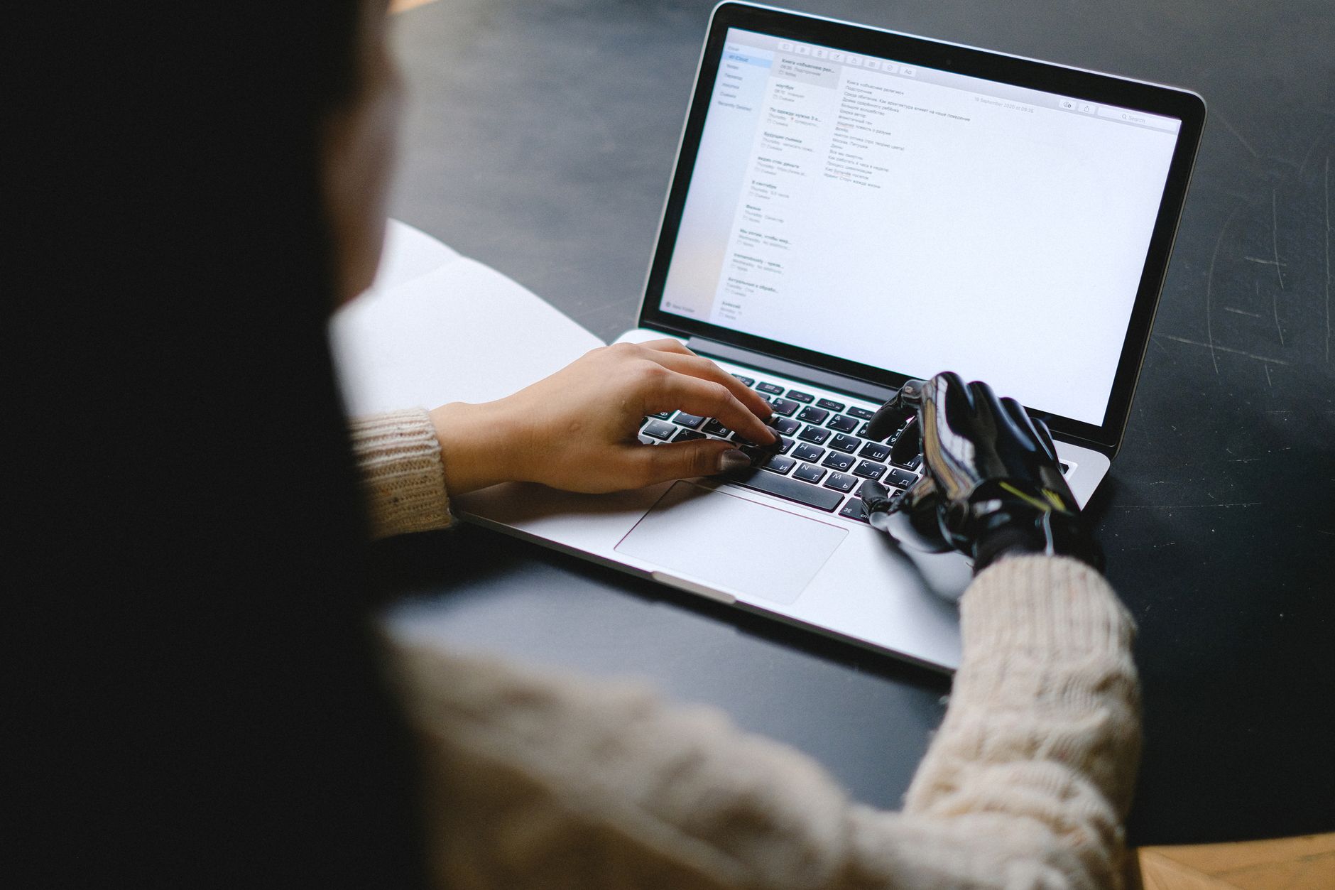 a marketer writing content on a laptop with an AI assistant interface on screen