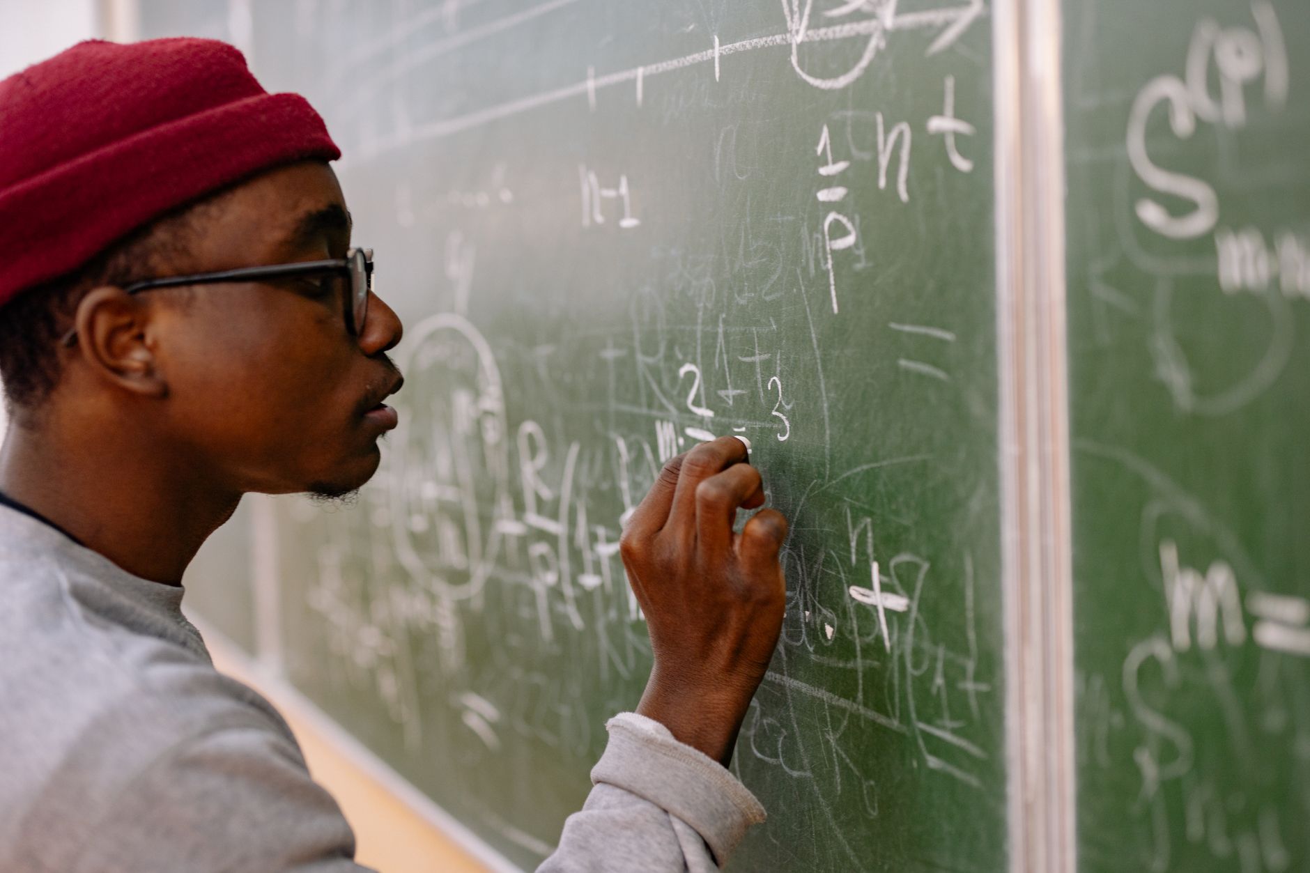 a student working through math equations on a tablet with a stylus