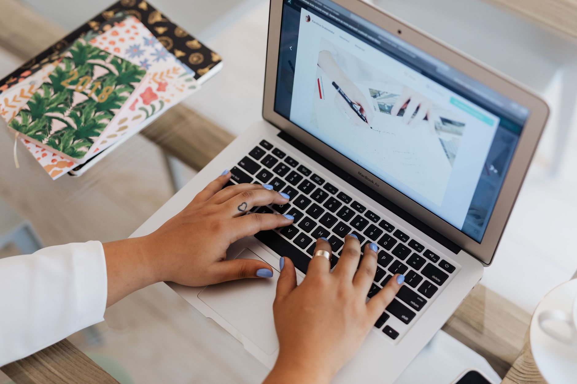 a person comparing AI writing tools on a laptop screen with two browser tabs open