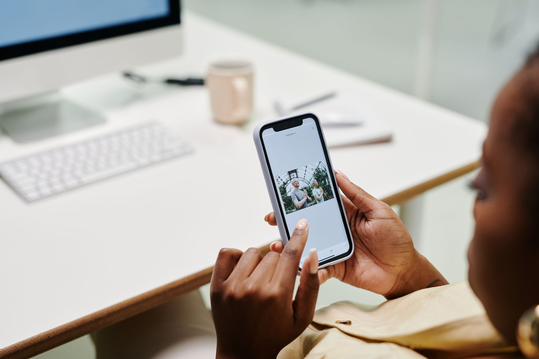 Adult using smartphone app showing generated AI companion photo and chat